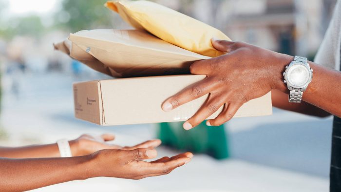 Person handing over packages to another person